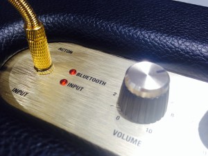 The Acton's connections include Bluetooth and 3.5mm aux port, for which Marshall provides a coiled guitar-style 3.5mm cable.  It has three analog interaction knobs for bass, midrange and treble adjustment.