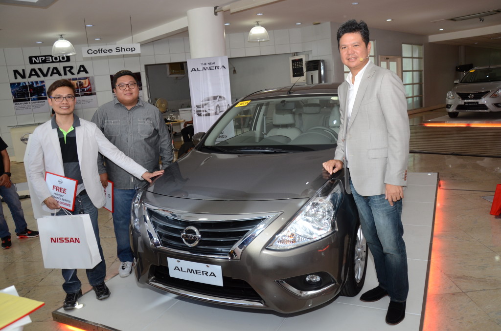  (From left) Sherex Denver Corpuz and Randall Negado, who pride themselves as owners of a Nissan Almera with Toti Zara, NPI President and Managing Director during the launch.