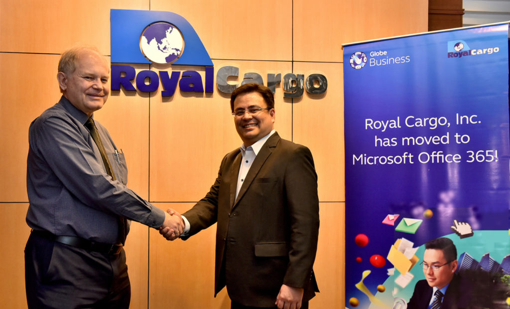 (From R-L) Dion Asencio, Globe Vice President for Enterprise Sales and Michael Raeuber, Royal Cargo Group Chief Executive Officer seal the partnership between Globe and Royal Cargo for the use of Microsoft Office 365. 